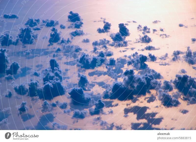 Beautiful view from window of plane flying over clouds and sea surface sky water sun ray cloudscape blue panorama landscape clouds background open space weather