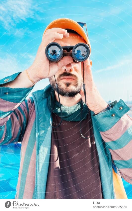 Man observing something through binoculars Binoculars search Amazed inquisitorial Observe Human being Hipster Looking Discover portrait bearded Modern Blue