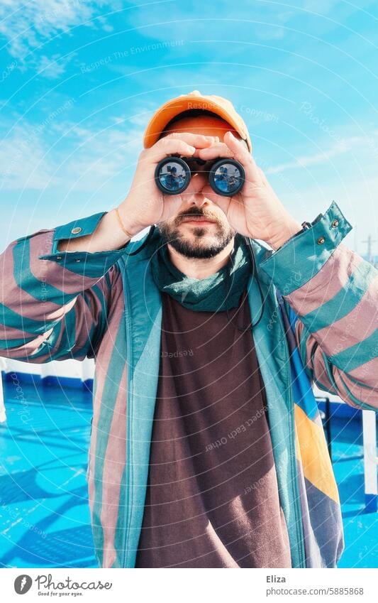 Man observing something through binoculars Binoculars search Amazed inquisitorial Observe Human being Hipster Looking Discover portrait bearded Modern Blue