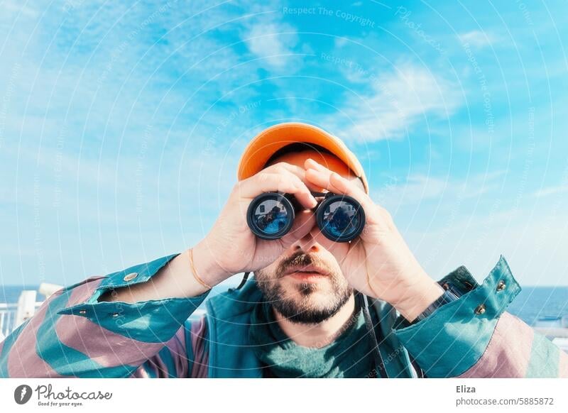 Man observing something through binoculars Binoculars search Amazed inquisitorial Observe Human being Hipster Looking Discover portrait bearded Modern Blue
