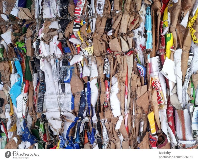 Colorful compressed cardboard boxes and packaging for recycling in a dumpster in the parking lot of a supermarket in Oerlinghausen near Bielefeld on Hermannsweg in the Teutoburg Forest in East Westphalia-Lippe