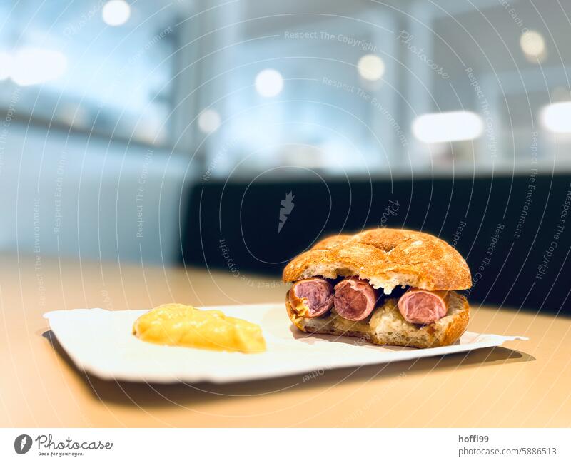 Sausage in a roll on cardboard with mustard bockwurst Roll Mustard paper plates Meat Fast food Snack Meal Snack bar Fastfoo Food Colour photo Delicious