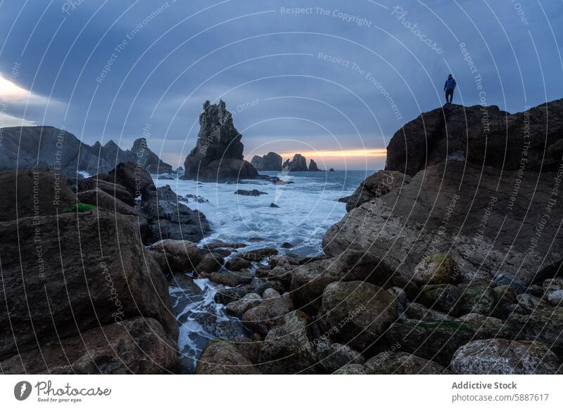 Man on rocks at Costa Quebrada, Cantabria during sunset costa quebrada cantabria spain explorer seashore boulders shoreline ocean water coast coastal landscape