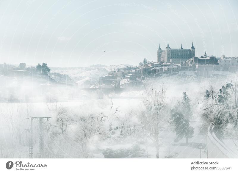 Misty winter view of Toledo, Spain under a cover of snow toledo spain landscape mist alcazar historic frost serene castilla la mancha snowy city cold season