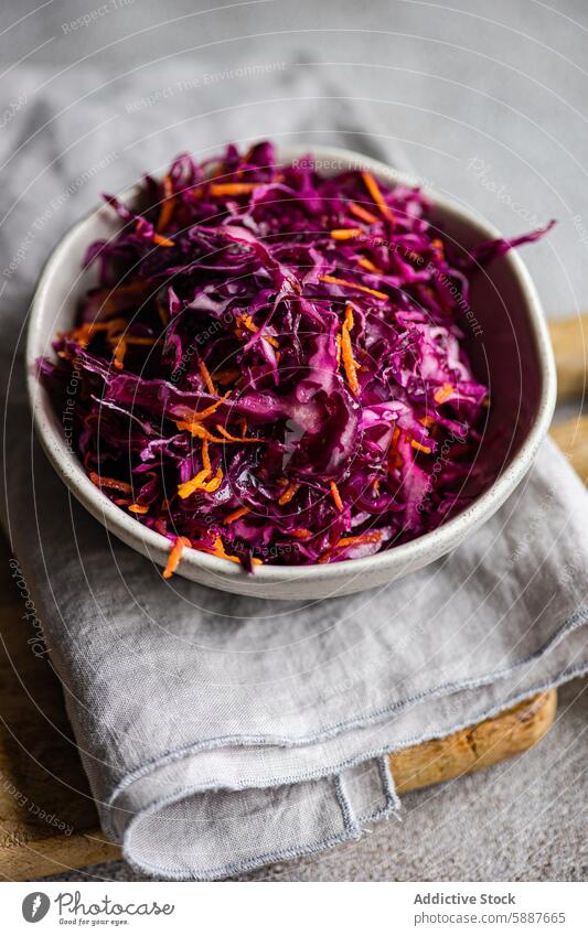 Red cabbage and carrot salad with boiled bulgur for lunch bowl red cabbage healthy raw dietetic vibrant fluffy white gray linen napkin food vegetable meal