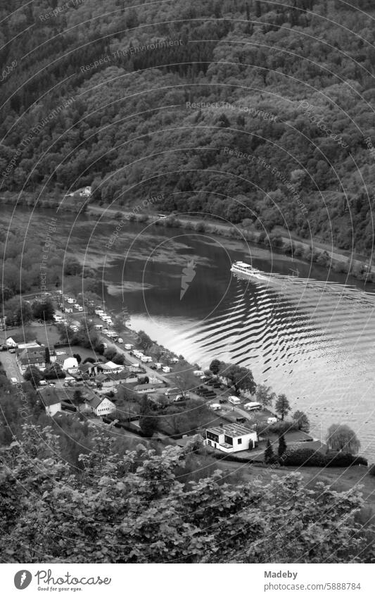 Magnificent panorama on the Moselle with a magnificent landscape and modern bridge between mountain and valley in sunshine in Traben-Trarbach in the district of Bernkastel-Wittlich in Rhineland-Palatinate in Germany in neo-realistic black and white