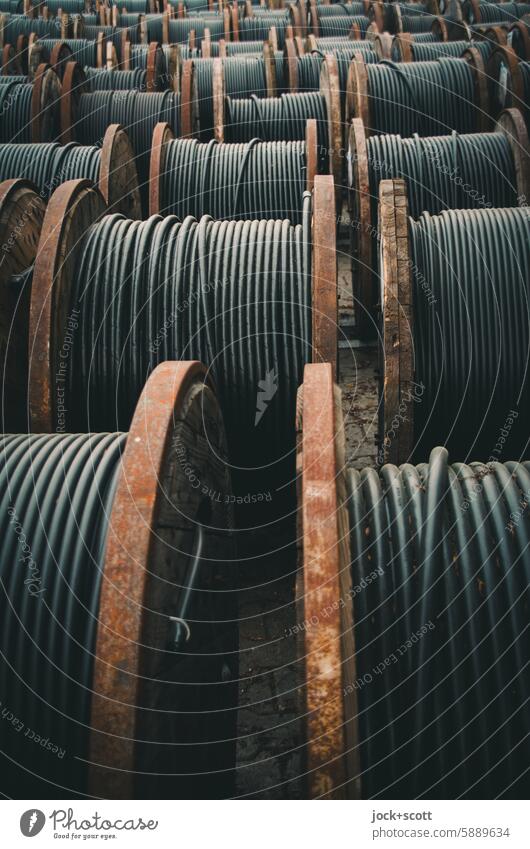 Black underground cables on wooden cable drums power cable power line Transmission lines Many Cable Power transmission Energy industry storage Industry