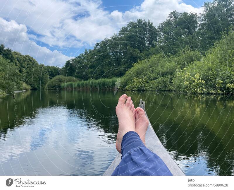 Barefoot feet somersaulting on canoe with river in the background River Nature Canoe Relaxation vacation Leisure and hobbies relaxation Adventure Canoe trip