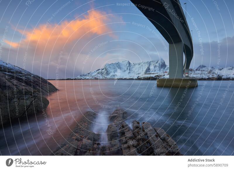 Dramatic sunset over snowy mountains and bridge in Lofoten landscape water lofoten norway tranquil dramatic color illumination modern architecture