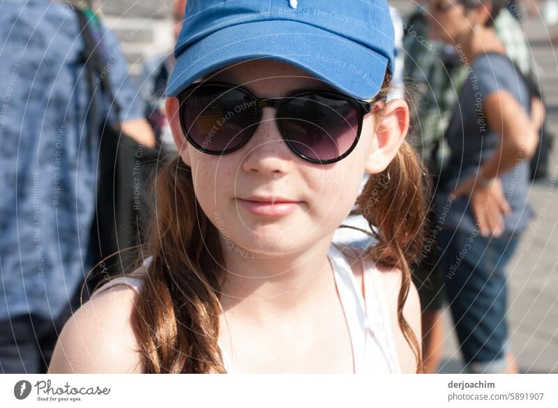 The girl with the sunglasses and the long hair as well as the blue head cap, she looks really cool. sunglasses model Sunglasses Colour photo Human being Day