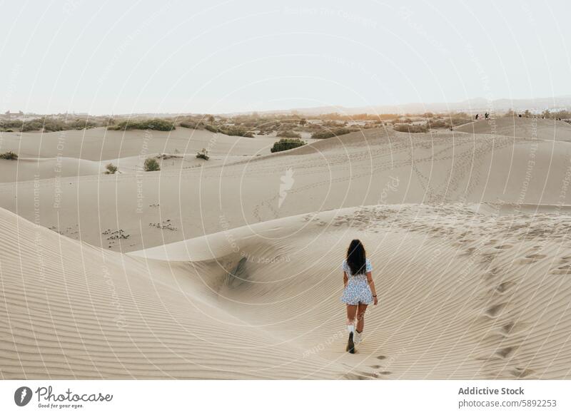 Exploring a desert landscape during a summer vacation woman dune walking holiday sand tranquil sunset sky freedom nature sandy travel adventure serene