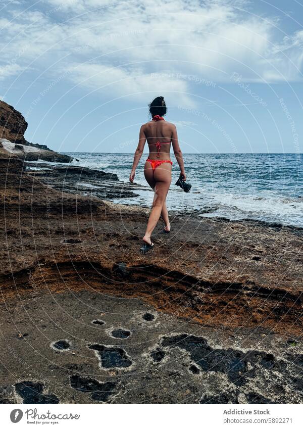 Summer holiday stroll by a rocky seaside summer woman beach swimwear ocean wave shore sky volcanic coast walk nature outdoor scenic view landscape travel