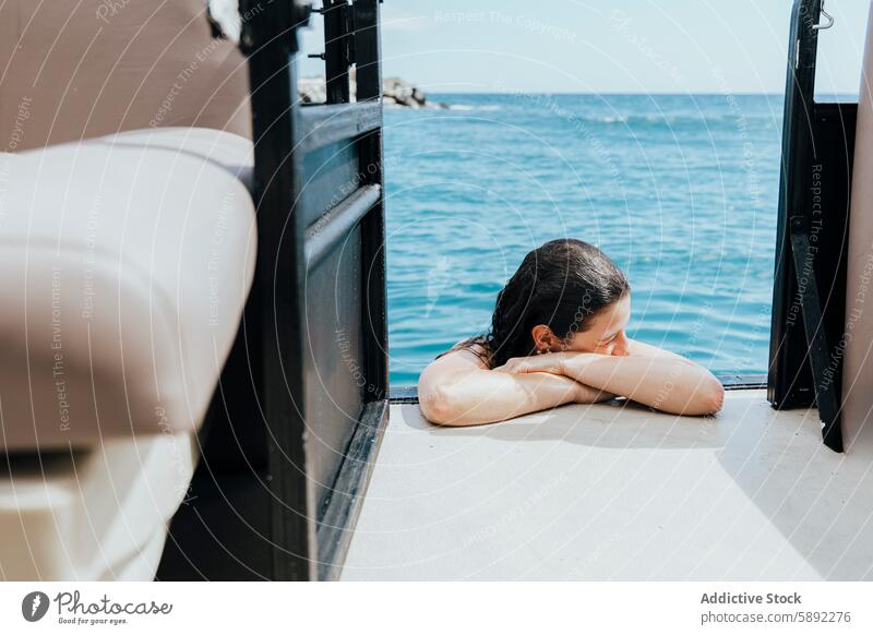 Woman relaxing by the sea on a summer holiday woman windowpane seascape peaceful cozy rest head arm enjoy serene view sunny waterfront leisure vacation tranquil