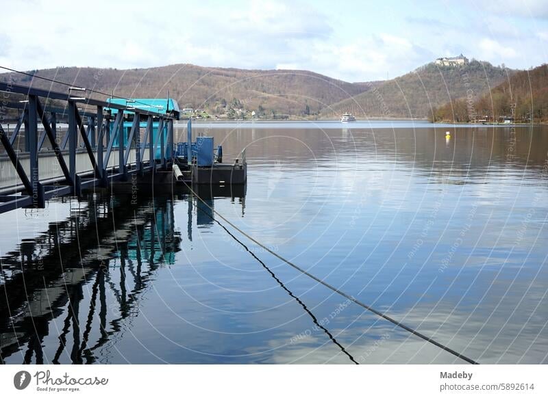 Mooring for the excursion boats at the dam wall of Lake Edersee in spring in the sunshine with a view of Waldeck Castle or Waldeck Palace in the district of Waldeck-Frankenberg in Hesse
