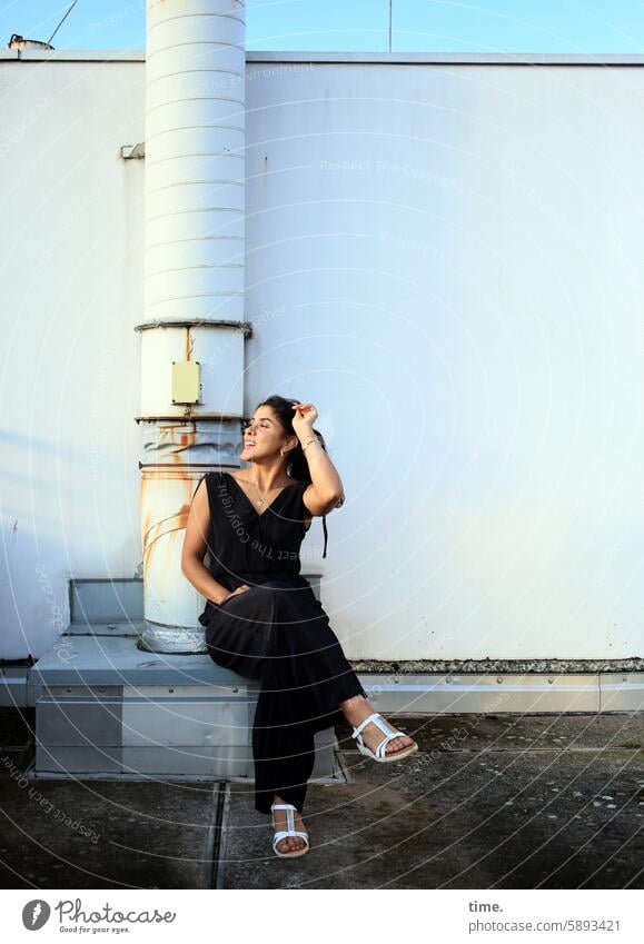 Woman on a parking deck in the evening sun Long-haired Looking portrait Good mood Observe Feminine Jewellery Curiosity Laughter Concentrate Watchfulness