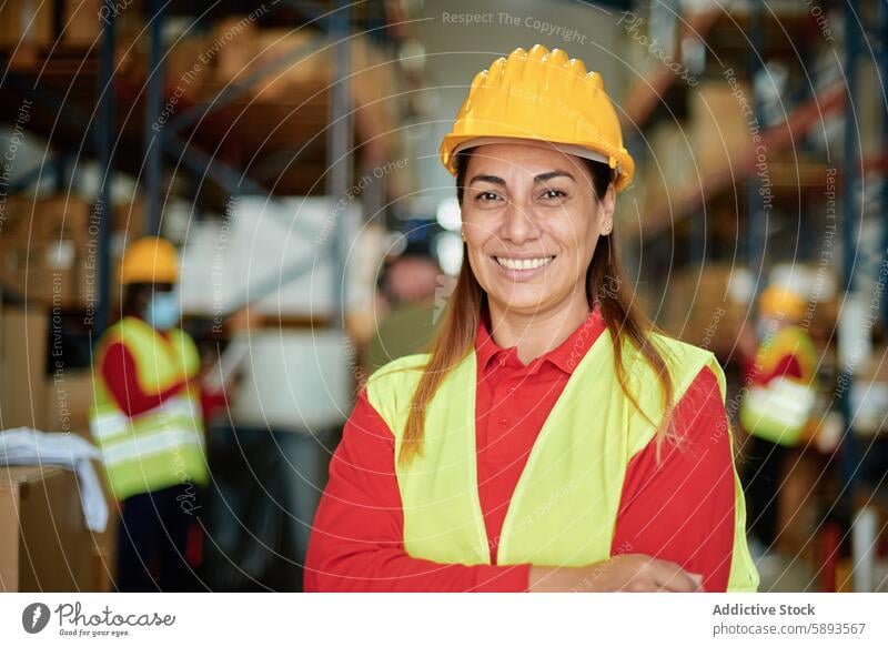 Confident Warehouse Worker Smiling in Industrial Environment warehouse worker female smile confident hard hat high-visibility vest industrial environment