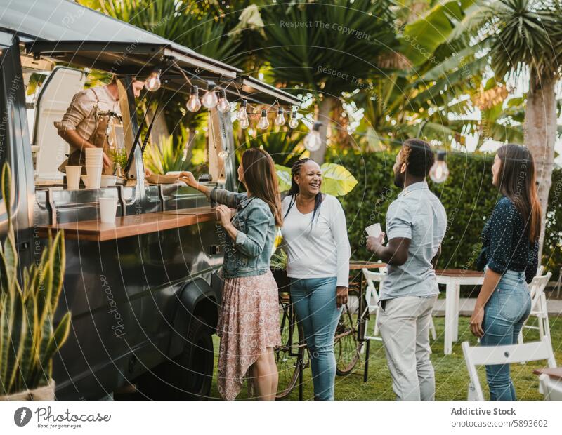 Multiracial friends talking near food truck in park smile queue summer daytime happy women seller order buy takeaway together diner to go cheerful diverse