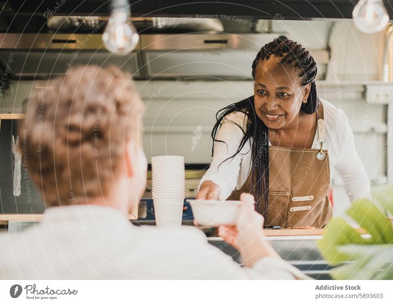 African chef woman serving take away order inside food truck - Focus on senior woman face africa african african american bar beverage black business cafeteria