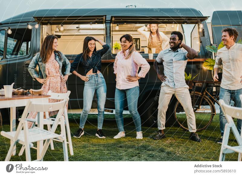 Multiracial friends dancing near food truck in park dance casual hand on waist swing together lawn men women modern joy rest summer relax weekend lifestyle