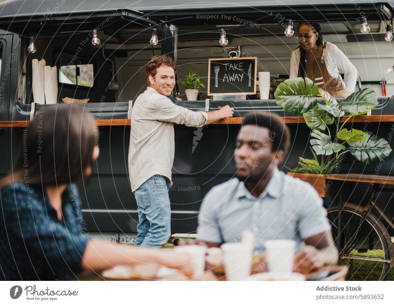 Multiracial people eating at food truck outdoor - Focus on center man face african bar beverage business city counter customer delivery dinner event fast