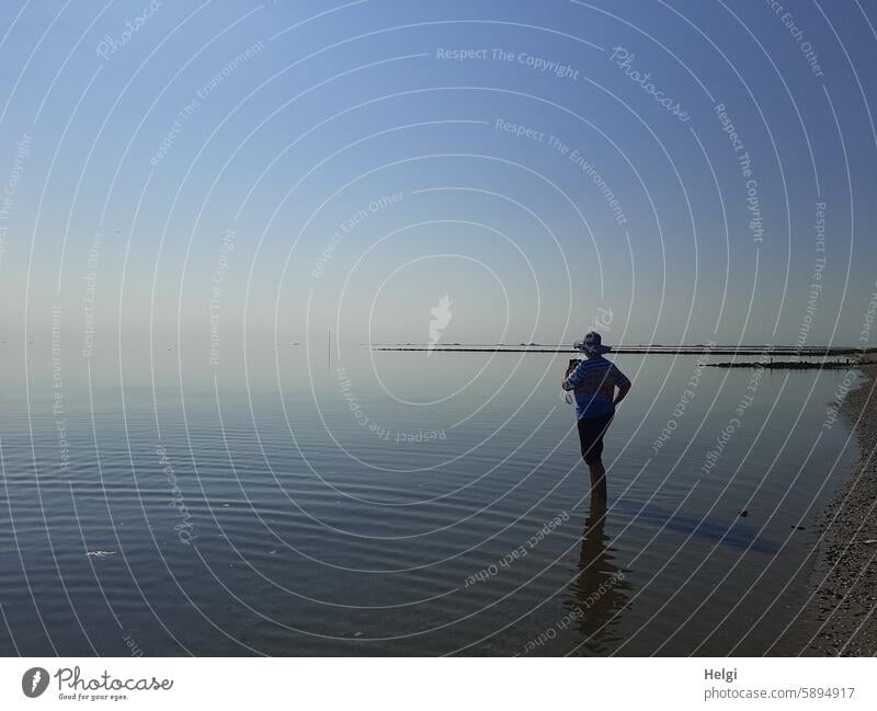 Hallig Gröde | Silhouette of a woman with sun hat and smartphone in the Wadden Sea Woman Human being Senior citizen Sunlight Light Shadow Ocean North Sea