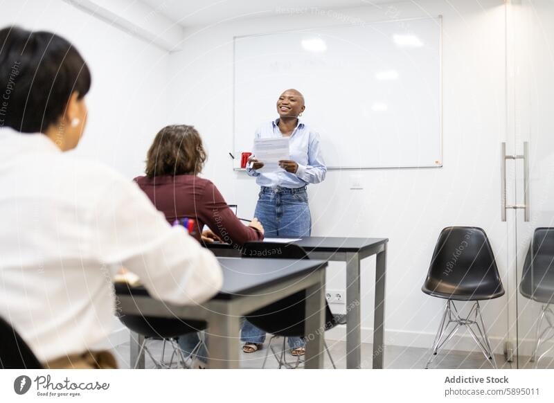 African American woman leading a discussion in a classroom african american leader student adult education learning modern table chair whiteboard engagement