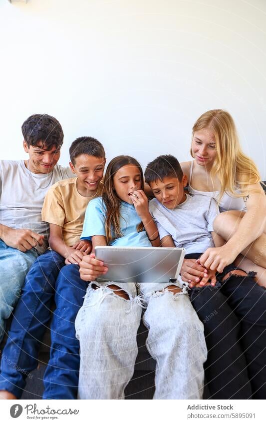 Triplets sharing a tablet and enjoying time together triplet sibling digital device family bonding casual emotion cheerful engagement interaction technology