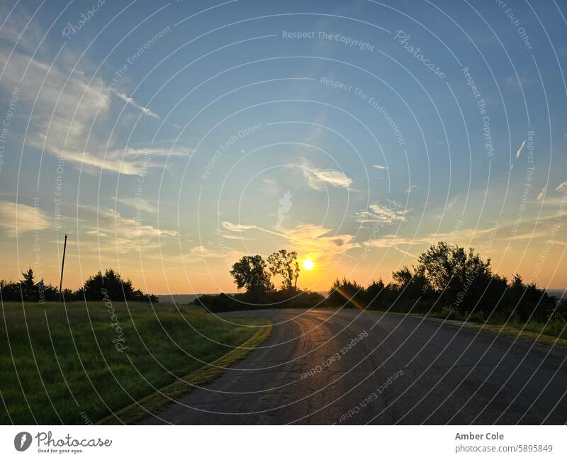 Sunrise reflects over road, off over a hill sunrise - dawn Morning Nature Country road Trees in the background Hello to morning morning mood Calm in the morning