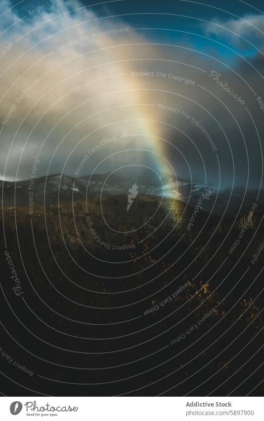 Rainbow emerging over snowy mountains rainbow palencia curavacas espiguete peak storm cloud landscape nature light scenic outdoor winter sky hill summit cold