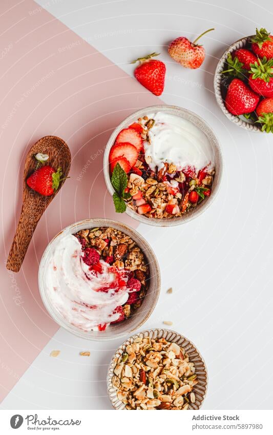 Healthy breakfast bowls with yogurt, granola, and fresh strawberries strawberry raspberry summer healthy fruit nut almond snack meal morning vibrant