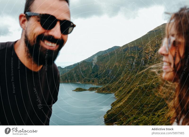 Couple enjoying scenic view of a lake in Sao Miguel, Azores. sao miguel azores couple man woman nature travel smile sunglasses happy lush green outdoors leisure
