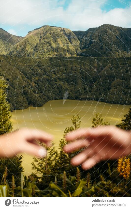 Hands framing a lush landscape in Sao Miguel, Azores. azores sao miguel nature scenic hands mountain valley lake greenery outdoors view travel tourism