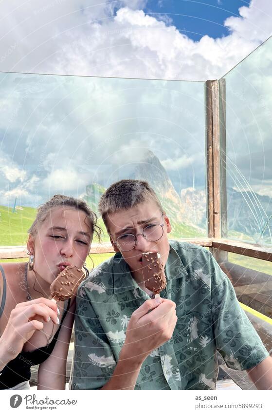 Refreshment after the hike Ice Delicious Break two Youth (Young adults) Summer Ice cream snack ardor Hot Eating Colour photo mountains Alps Green Tourism