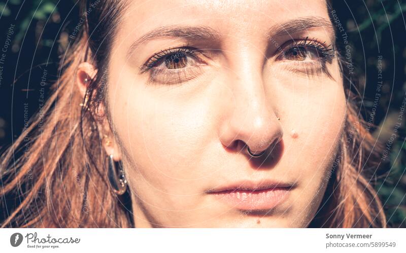 Close up face portrait from a Brazilian Woman, with sunlight in her face. enjoy a walk in the Botanic Garden in São Paulo, Brazil. woman brazilian hike garden