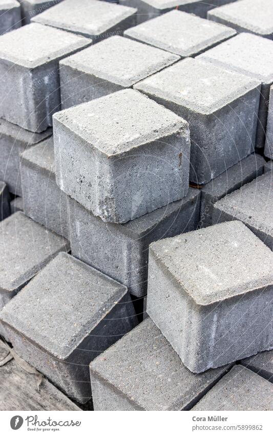 Stack of gray concrete paving stones construction Construction site Paving stone Paving work Gray Concrete Material Build Pave building material cube cubes