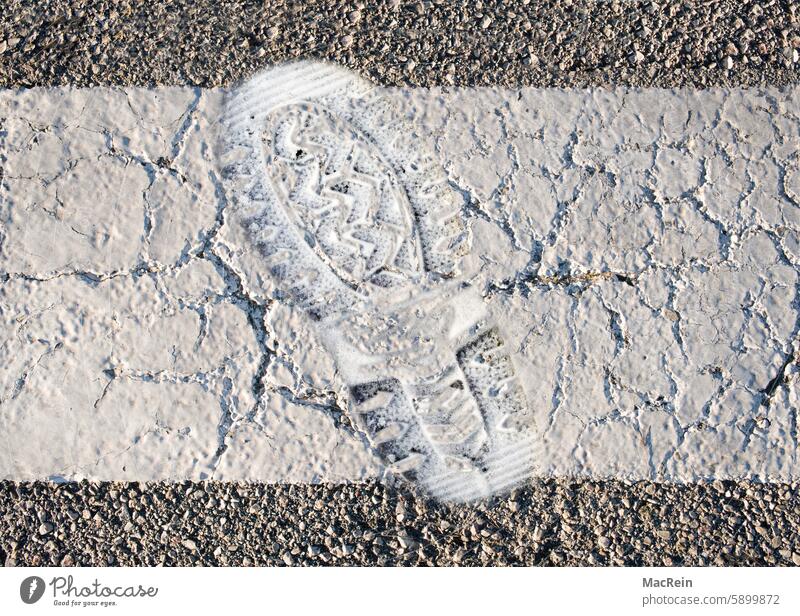 Profile imprint of a sneaker on a freshly marked road strip road marking freshly painted Road marking Sole imprint Sole profile sneaker print Exterior shot