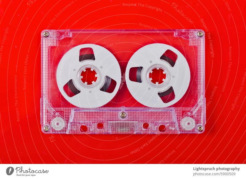 Vintage compact audio cassette isolated on red background. retro style old-fashioned analog directly above copy space arts culture and entertainment