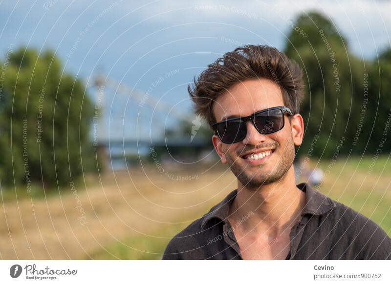 Portrait of a young man from India with an open shirt and sunglasses Man Athletic sexy Muscular kind Congenial Looking into the camera full of relish