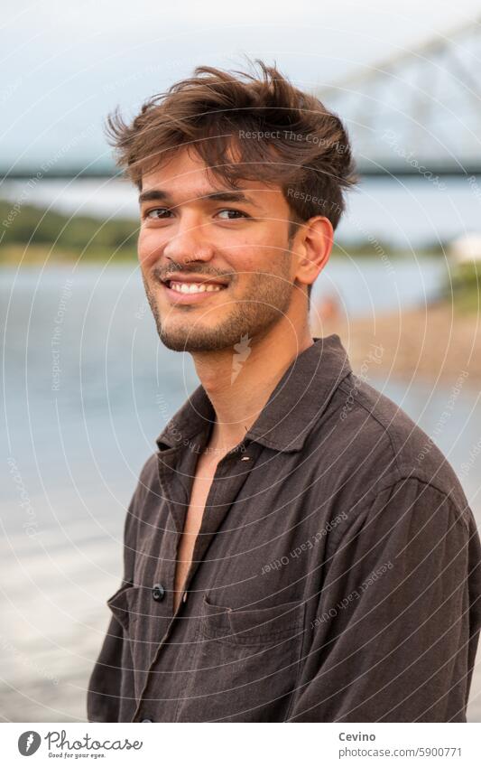 Portrait of a young man from India Man Athletic sexy Muscular kind Congenial Looking into the camera full of relish Exterior shot Nature Green erotic