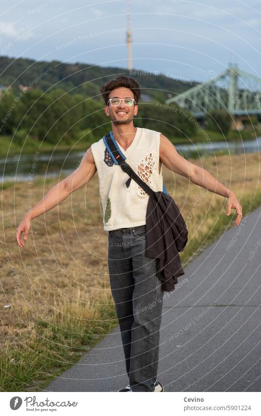 Young man from India dances by the river Man Athletic sexy Muscular kind Congenial Looking into the camera full of relish Exterior shot Nature Green erotic