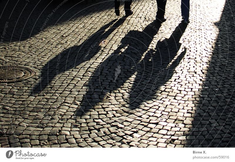 Shadows Pavement Alley Places Dark Eerie Threat 3 Deep Sunset streets Evening Feet Human being Cobblestones Paving stone