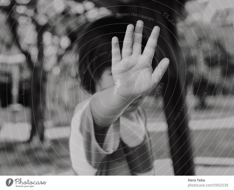 boy saying no with his hand. Stop. Hidden face. black and white photo Boy (child) Child chilhood Portrait photograph Hand no violence bullying