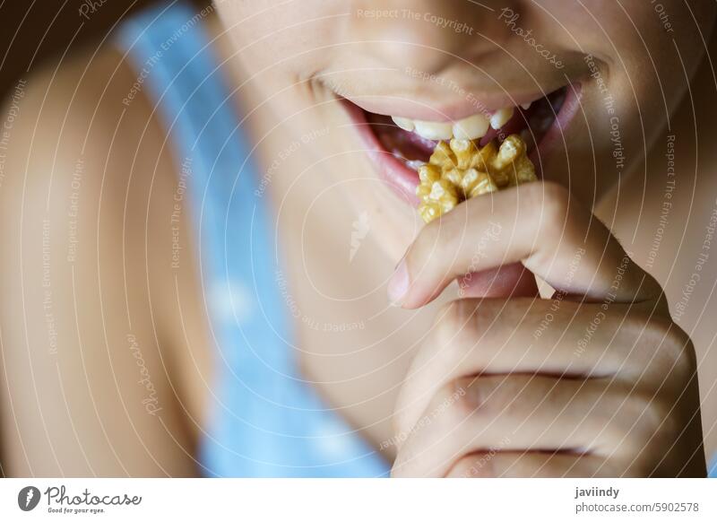 Crop unrecognizable teenage girl eating healthy walnut kernel Girl Walnut Eat Healthy Nut Hungry Fresh Kernel Diet Food Snack Protein Nutrition Mouth Open Bite