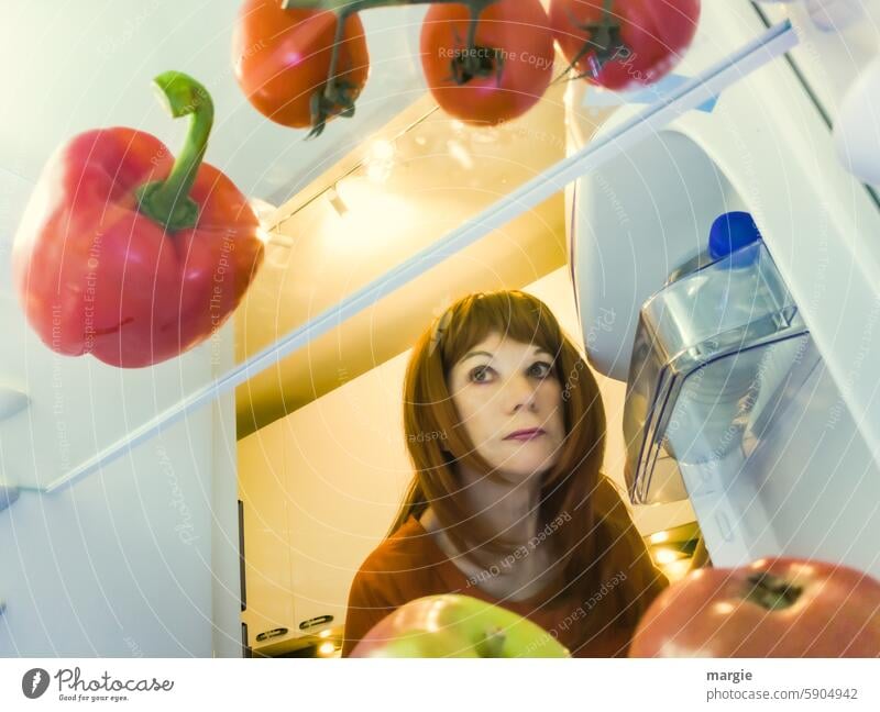 A woman only sees healthy food in her fridge Woman portrait Human being Face Icebox Healthy Eating apples Pepper Delicious Organic produce Food Apple