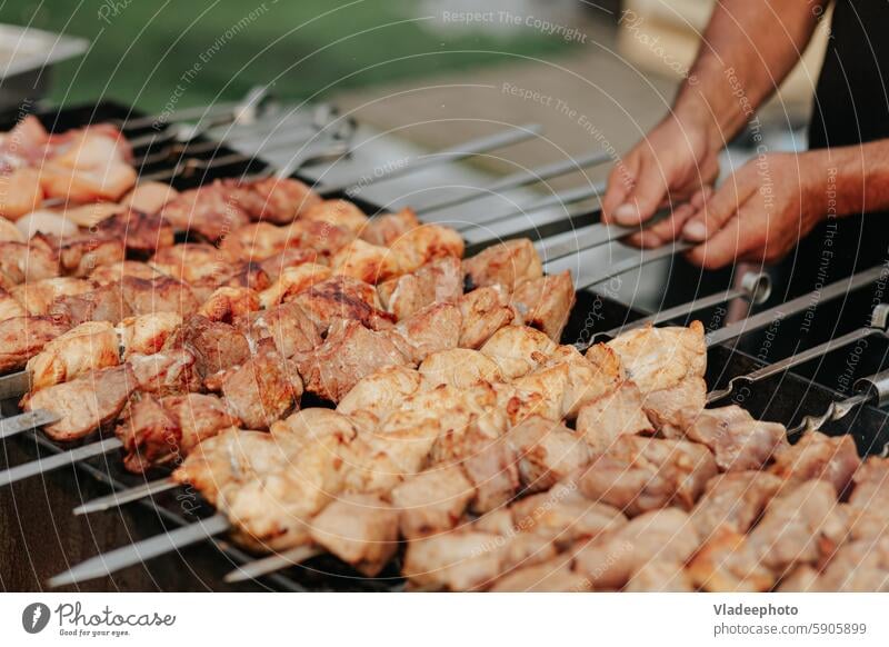 Frying shish kebab on the skewers in brazier. Fresh ruddy meat for barbecue grill on fire outdoor. food cooking picnic pork meal delicious shashlik bbq grilled