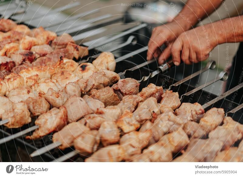 Frying shish kebab on the skewers in brazier. Fresh ruddy meat for barbecue grill on fire outdoor food cooking picnic pork meal delicious shashlik bbq grilled