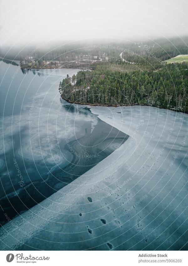 Aerial view of a foggy, frozen lake in Lapland aerial view lapland forest nature snow splendor cold tree winter serene landscape wilderness outdoors scenic