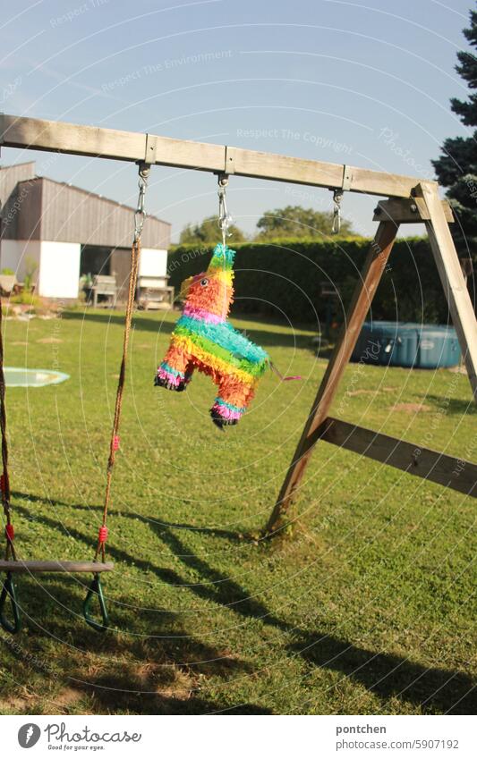 a pinata hangs from a swing frame. children's birthday party Childrens birthsday Party game variegated Rocking scaffold Birthday Feasts & Celebrations