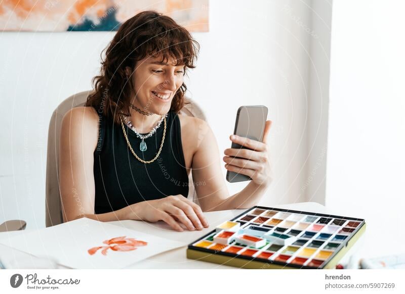 artist woman using his smartphone creativity photography technology indoors occupation smart phone lifestyle wireless technology ideas equipment design