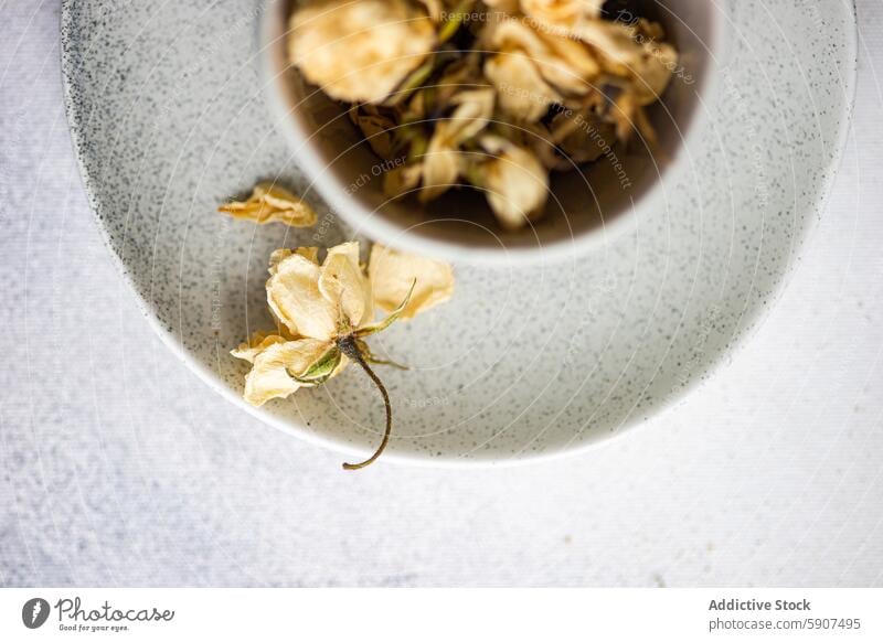 Dried rose in a ceramic bowl on a white linen backdrop dried rose minimalism serenity delicate floral dry flower decoration nature beauty aged vintage petals